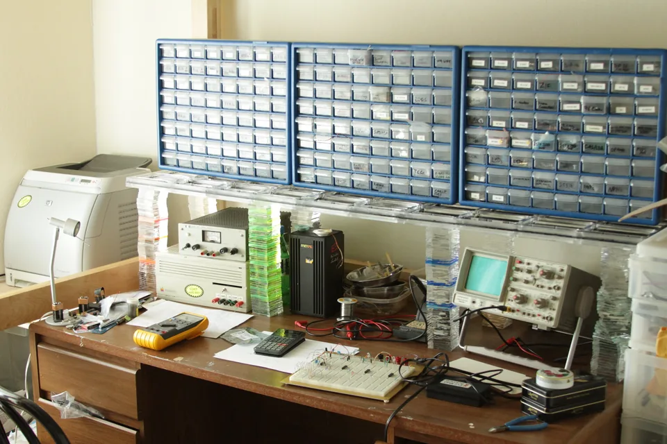 Electronics workbench with test equipment and parts drawers